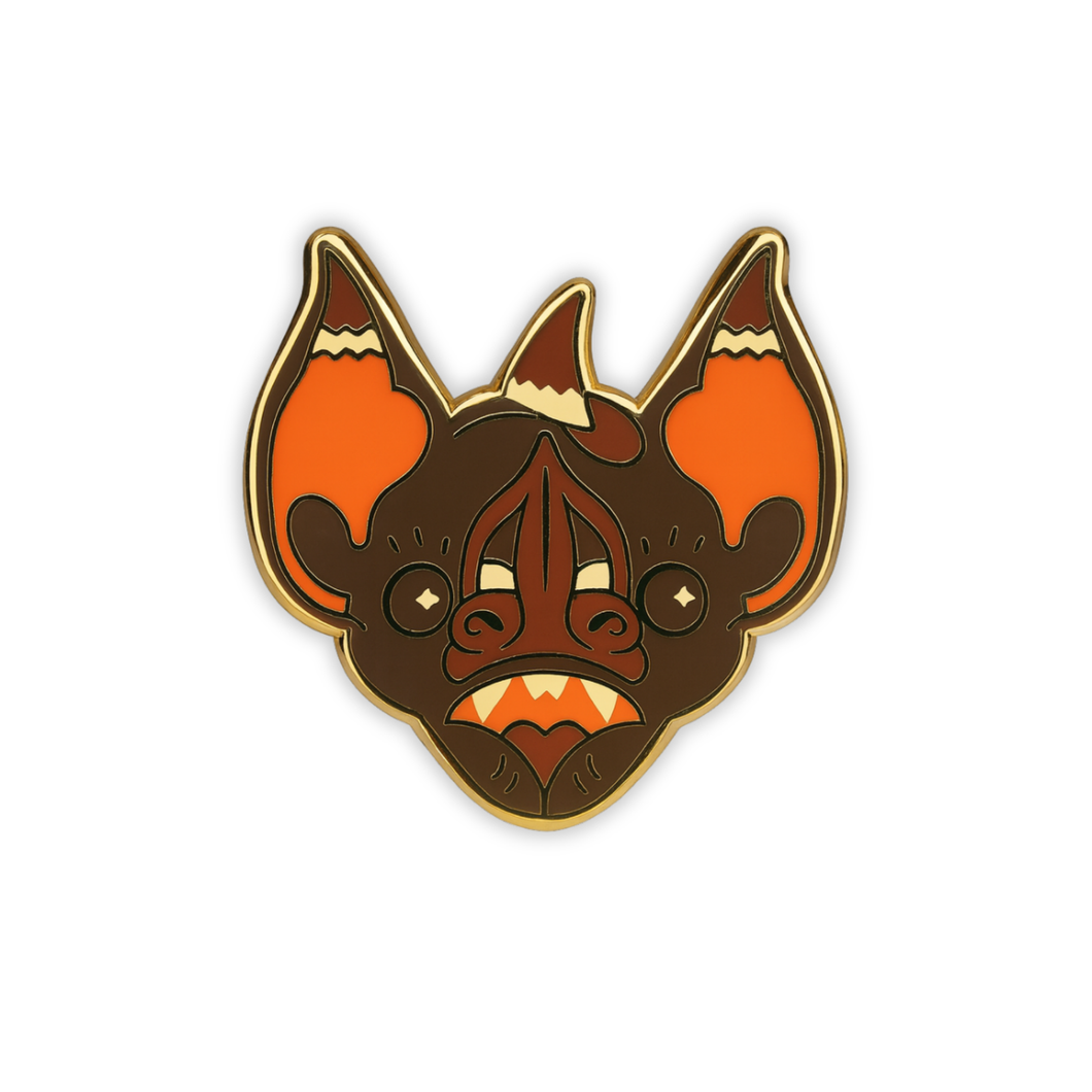 Stylized Chestnut Short-Tailed bat head enamel pin wearing a witch hat on a white background