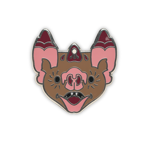 Stylized vampire bat head enamel pin on a white background