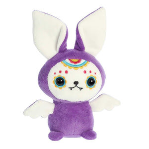 Stuffed purple sugar skull bat toy with white ears, white wings, and embroidered white face with fangs