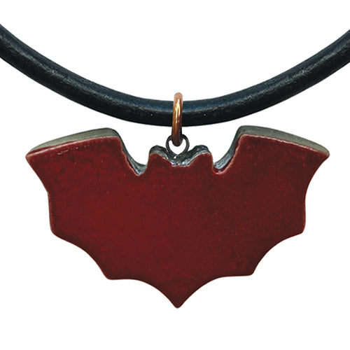 Deep red bat-shaped pendant on a black cord against a white background