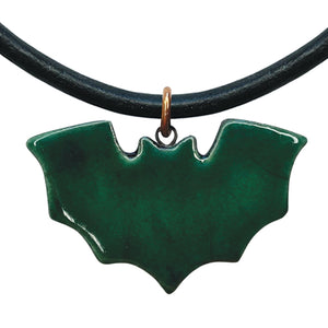 Green bat-shaped pendant on a black cord against a white background