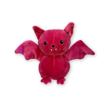 A mauve plush toy shaped like a cute bat with open wings, pointed ears, black embroidered eyes and mouth details, small fangs, and small feet, shown on a plain white background.