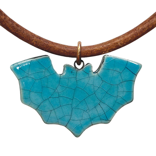Turquoise bat-shaped pendant on a brown cord against a white background