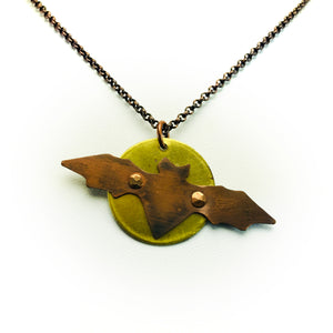 Necklace with hand cut copper bat attached with rivets to full moon made of brass